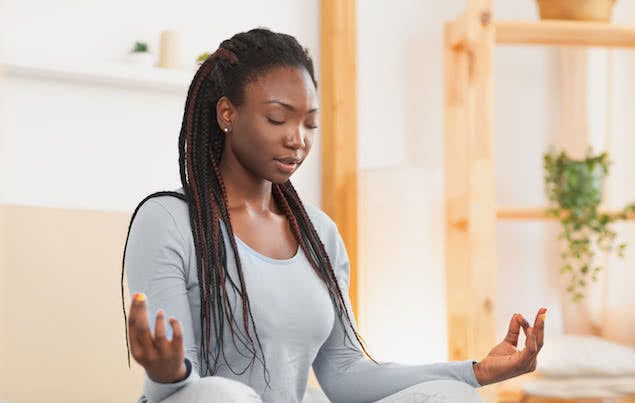 person doing yoga in bedroom