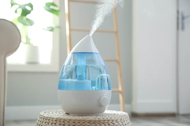 humidifier on table, which can help relieve a stuffy nose at night