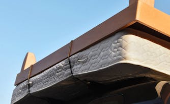 do i need a new mattress - image of old mattress strapped to a car