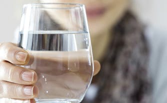 benefits of drinking water for sleep - bottle and glasses of water
