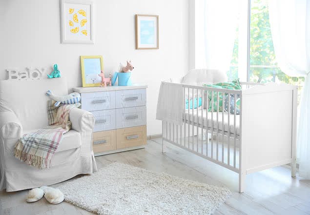 baby nursery with crib, dresser, and chair