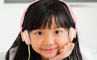 image of child listening to music in bed