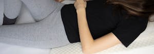 person sleeping on wedge pillow