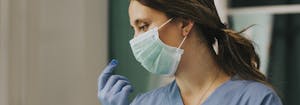 nurse in hospital wearing a face mask and gloves