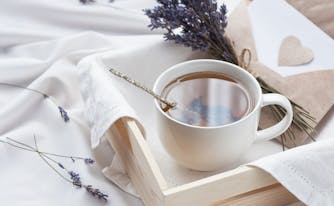 lavender and tea on top of bed
