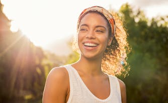 image of person smiling in sunshine