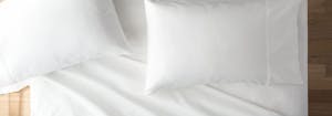 latex pillows on top of bed