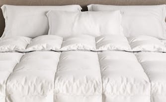 saatva down alternative comforter on top of bed