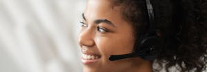 customer service representative with headset on smiling