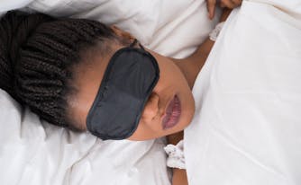 person wearing eye mask while sleeping