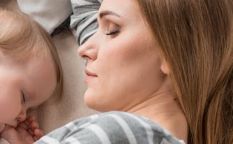 parent co-sleeping with baby in bed