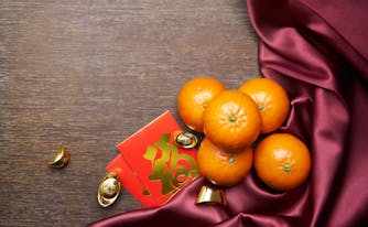 oranges, red envelopes, and gold coins for chinese new year