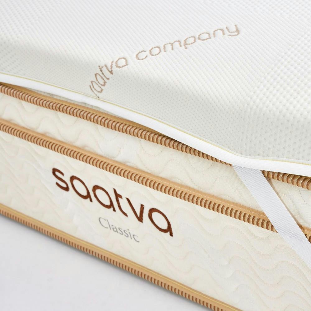 A close up of Saatva's award-winning, made-to-order and chiropractor-approved mattress, the classic innerspring, paired with a mattress topper