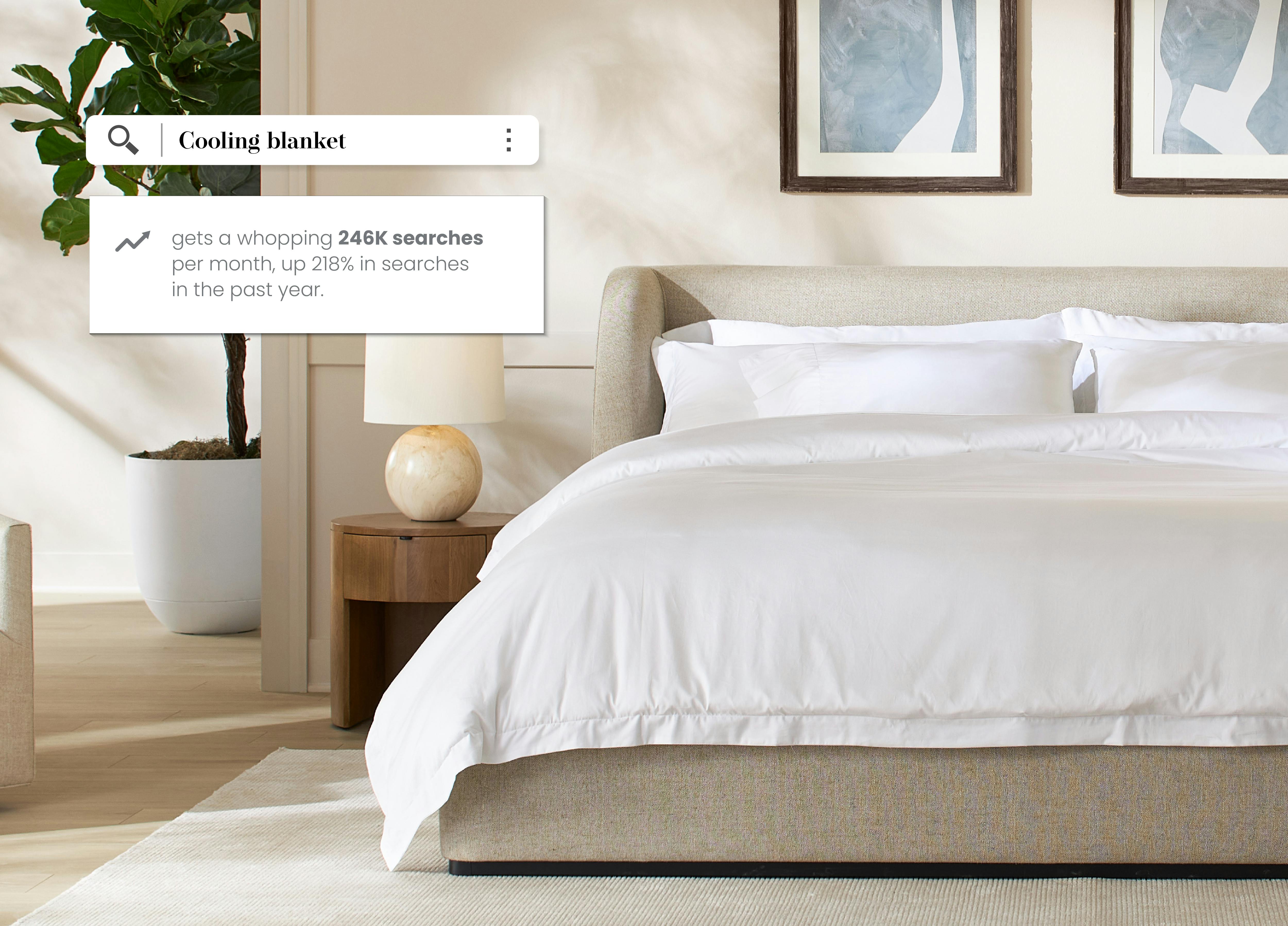 Saatva Cassis bed in natural linen, and organic sateen bedding, and pillows in a seaside bedroom.