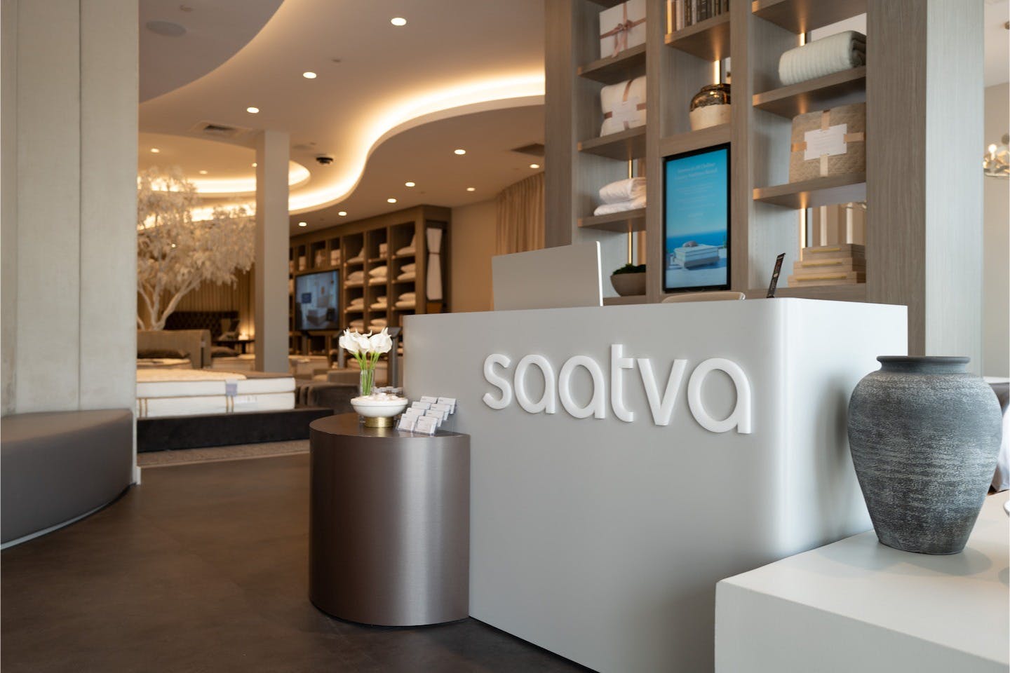 The elegant, modern, and luxurious interior and manager's desk of the Saatva Houston Viewing Room