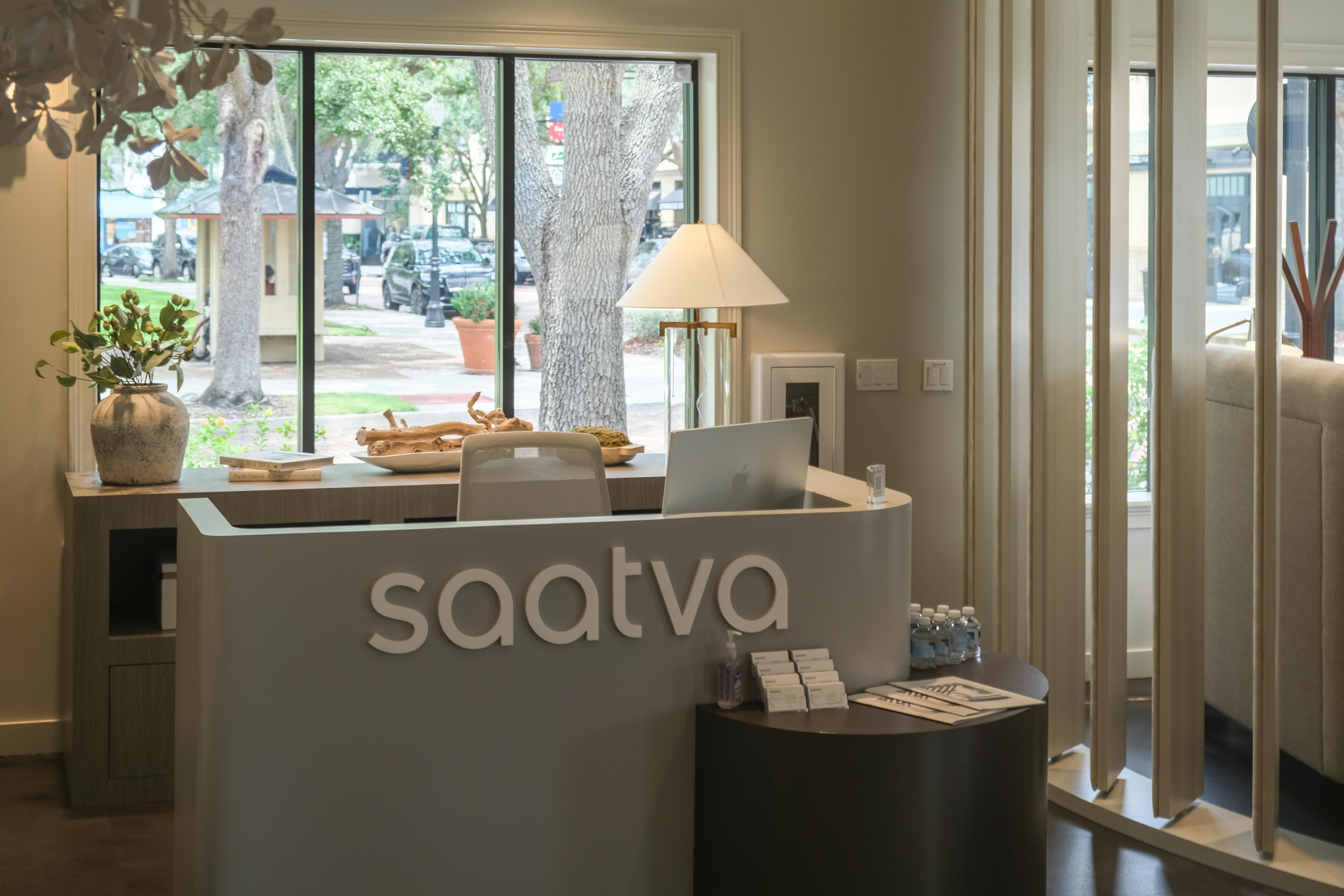 The elegant, modern, and luxurious interior and manager's desk of the Saatva Orlando Viewing Room