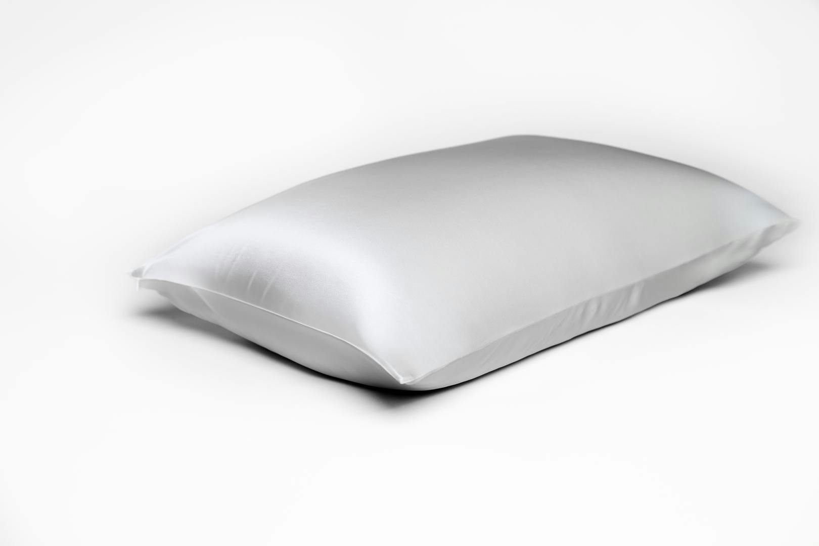 Saatva's Silk Pillowcase in White on a supportive and cozy memory foam pillow.