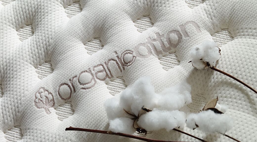 Closeup of the Saatva's award-winning Classic Mattress, decorated with raw organic cotton.