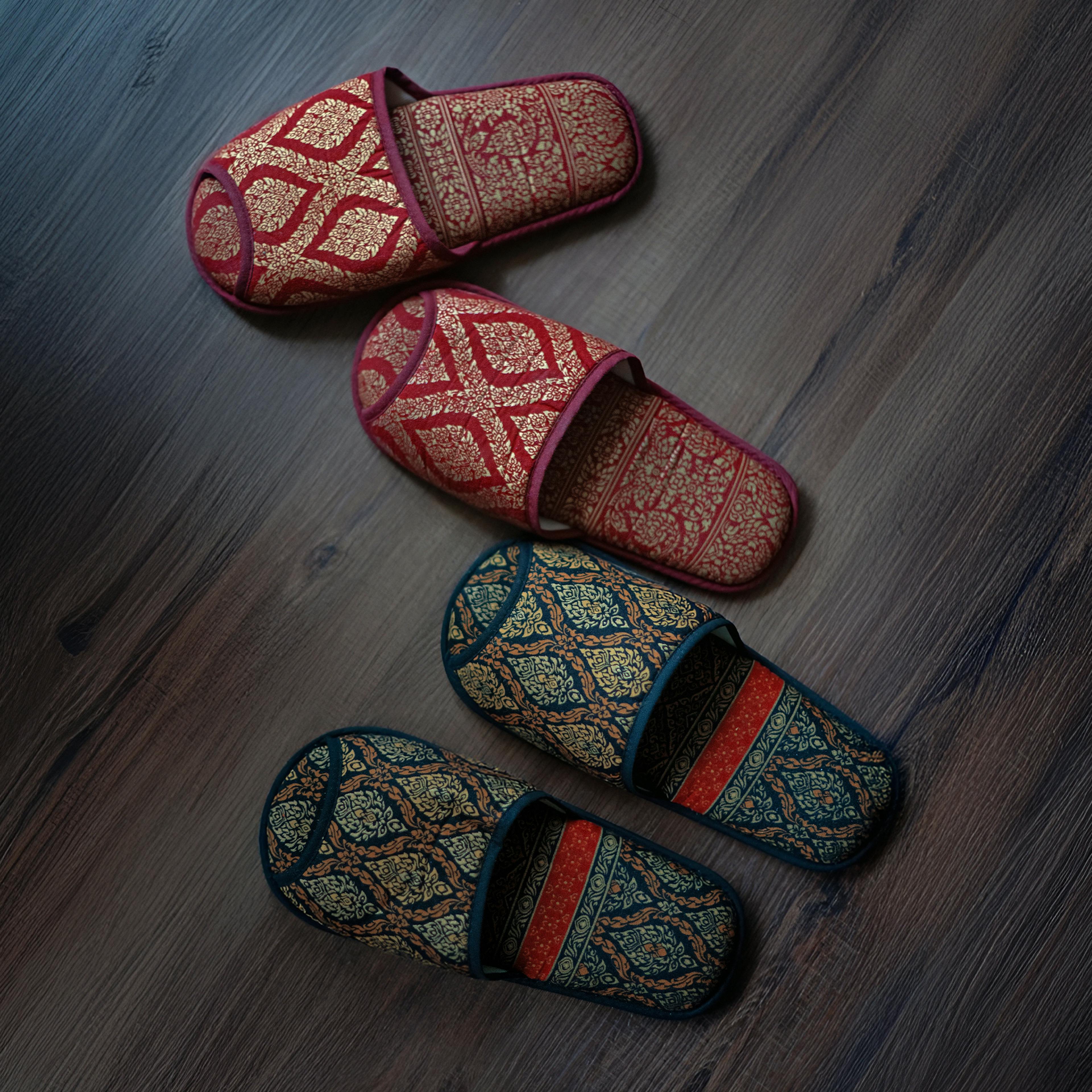 Traditional Thai slippers in shades of wine, green, and gold — ready for guests.