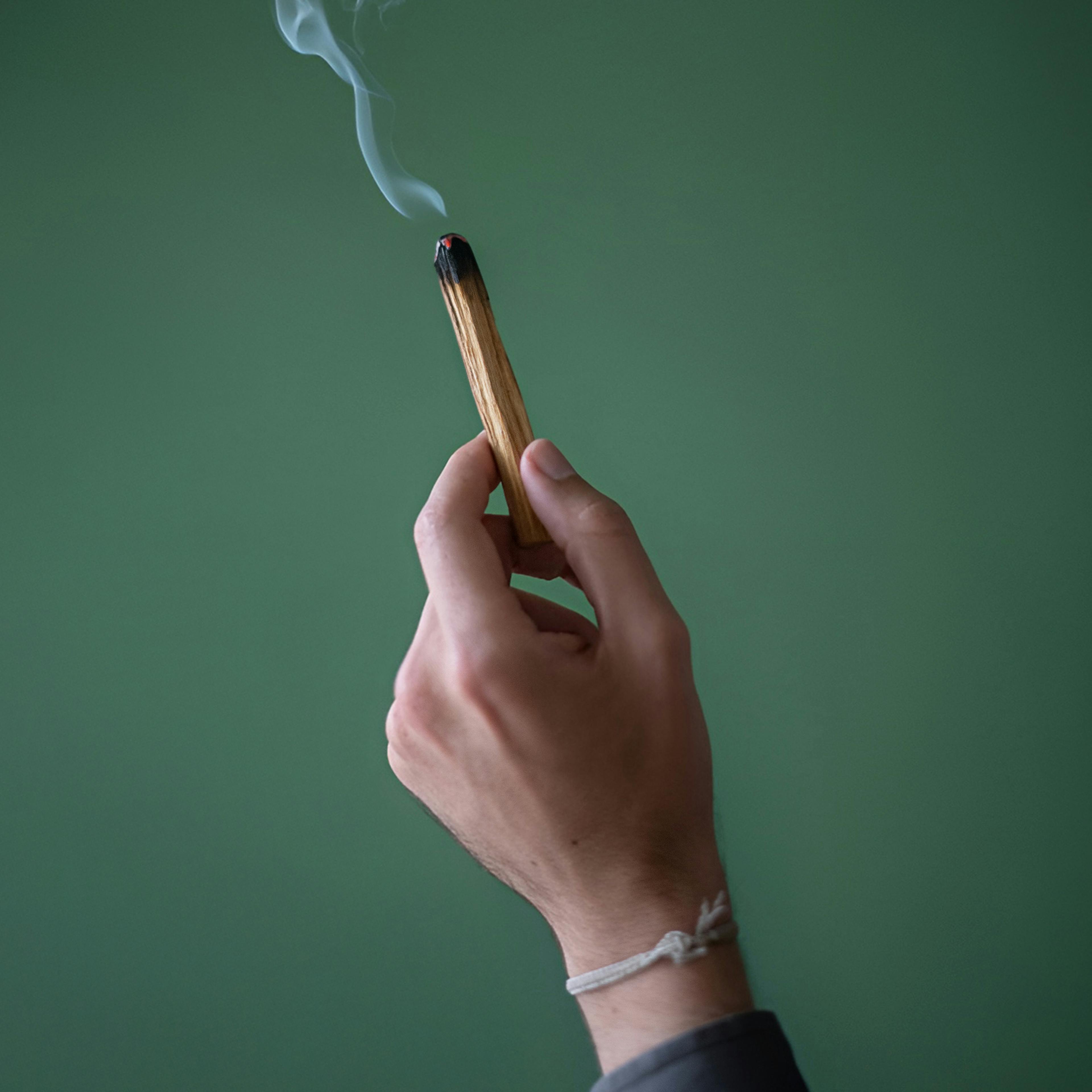 Palo Santo in a therapist’s hand — a scent ritual to purify the space before the session.