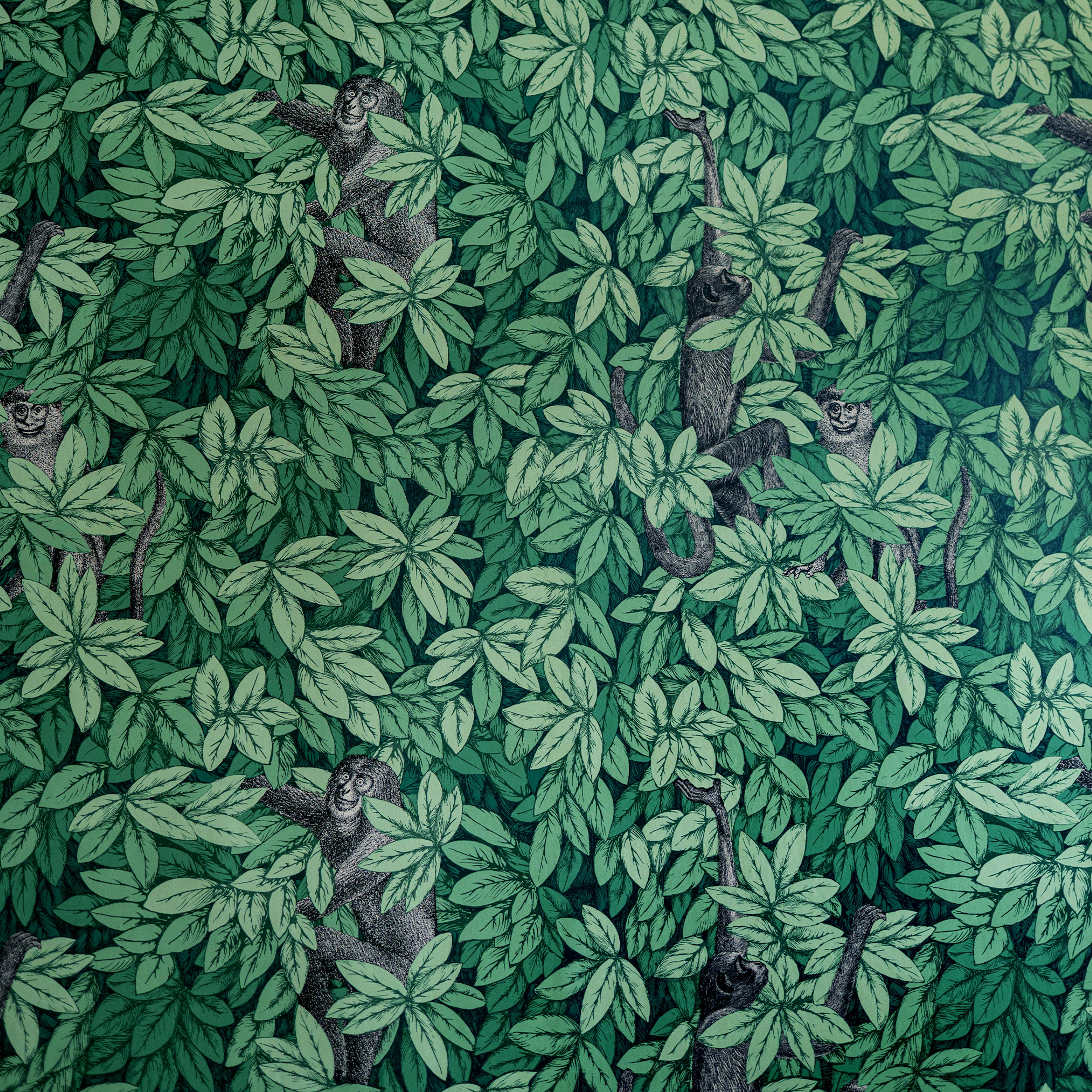 A soothing wall detail with tropical wallpaper — leafy palms and monkeys in a green palette.