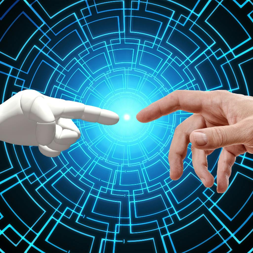 A robot hand touching with its finger a human finger