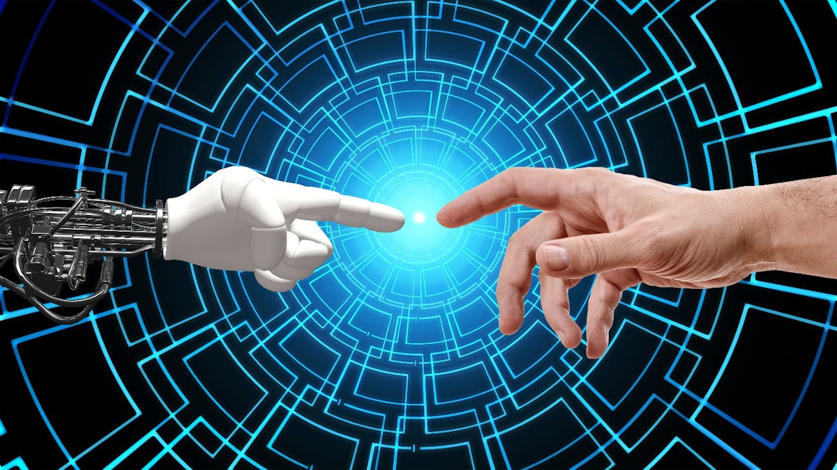 A robot hand touching with its finger a human finger