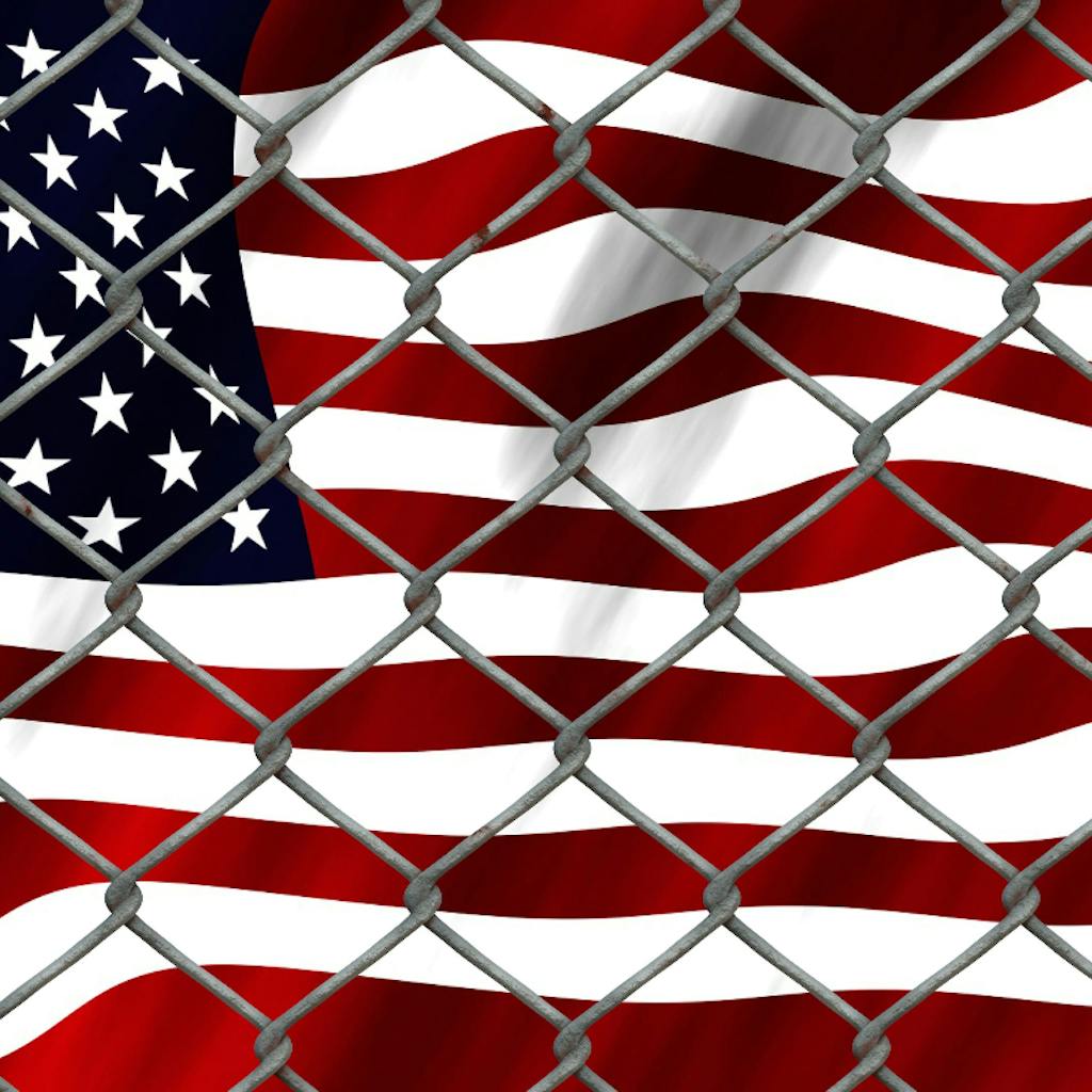 United States flag behind a fence