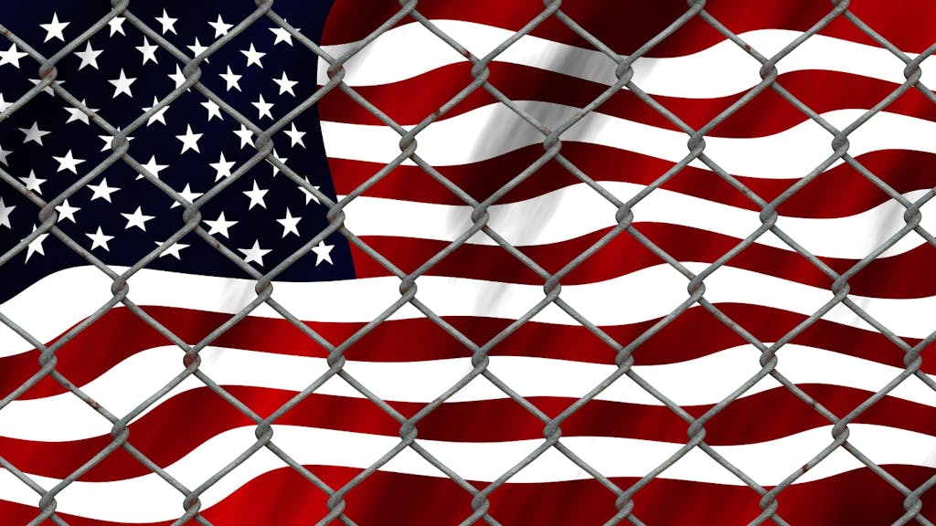 United States flag behind a fence