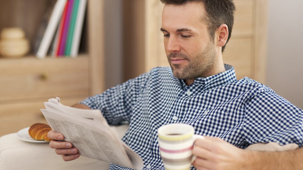 Smiling man with newspaper reading the news with a cup of coffee: <a href="https://www.freepik.com/free-photo/smiling-man-with-newspaper-cup-coffee_10676551.htm#page=3&query=tax%20updates%20good%20news&position=21&from_view=search&track=ais&uuid=40d61f3a-86d5-4e14-aa64-c42b548446ac">Image by gpointstudio</a> on Freepik