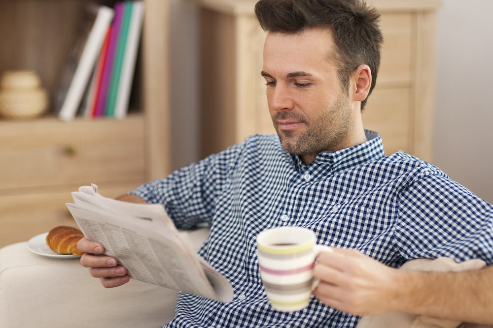 Smiling man with newspaper reading the news with a cup of coffee:  <a href="https://www.freepik.com/free-photo/smiling-man-with-newspaper-cup-coffee_10676551.htm#page=3&query=tax%20updates%20good%20news&position=21&from_view=search&track=ais&uuid=40d61f3a-86d5-4e14-aa64-c42b548446ac">Image by gpointstudio</a> on Freepik