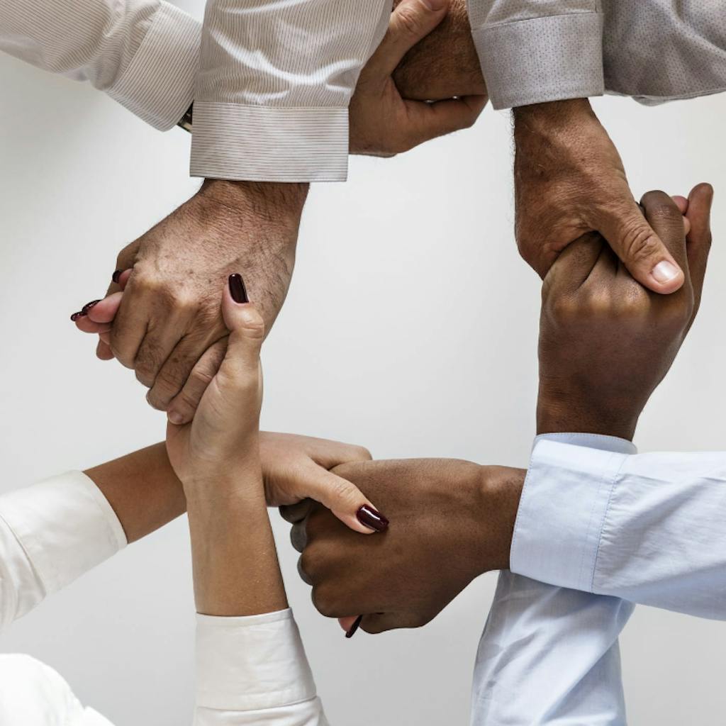 Three persons hand to hand