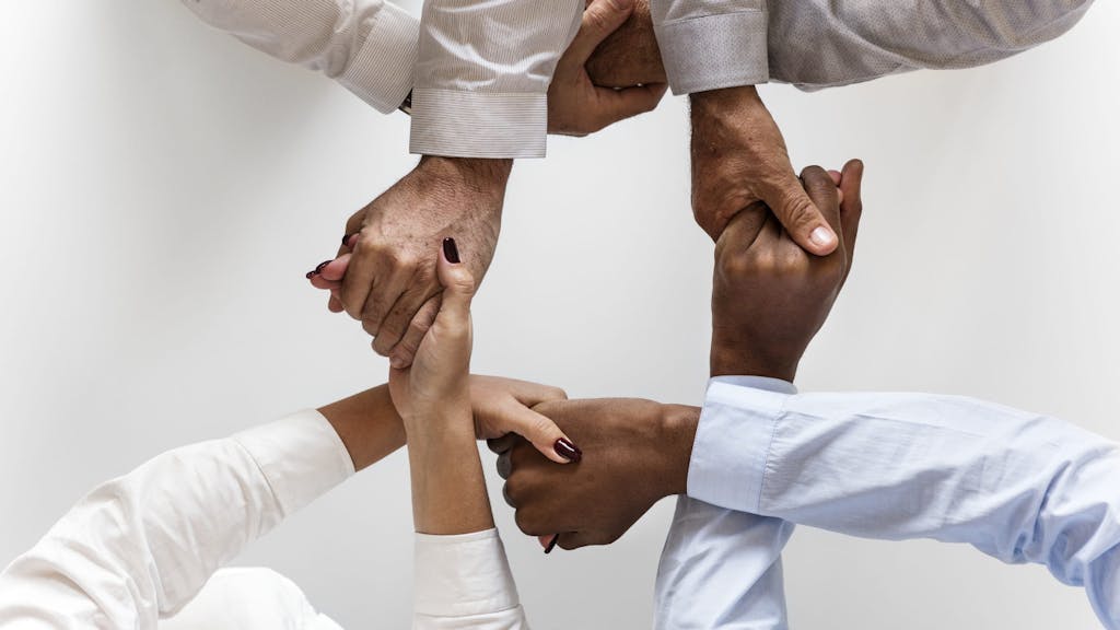 Three persons hand to hand