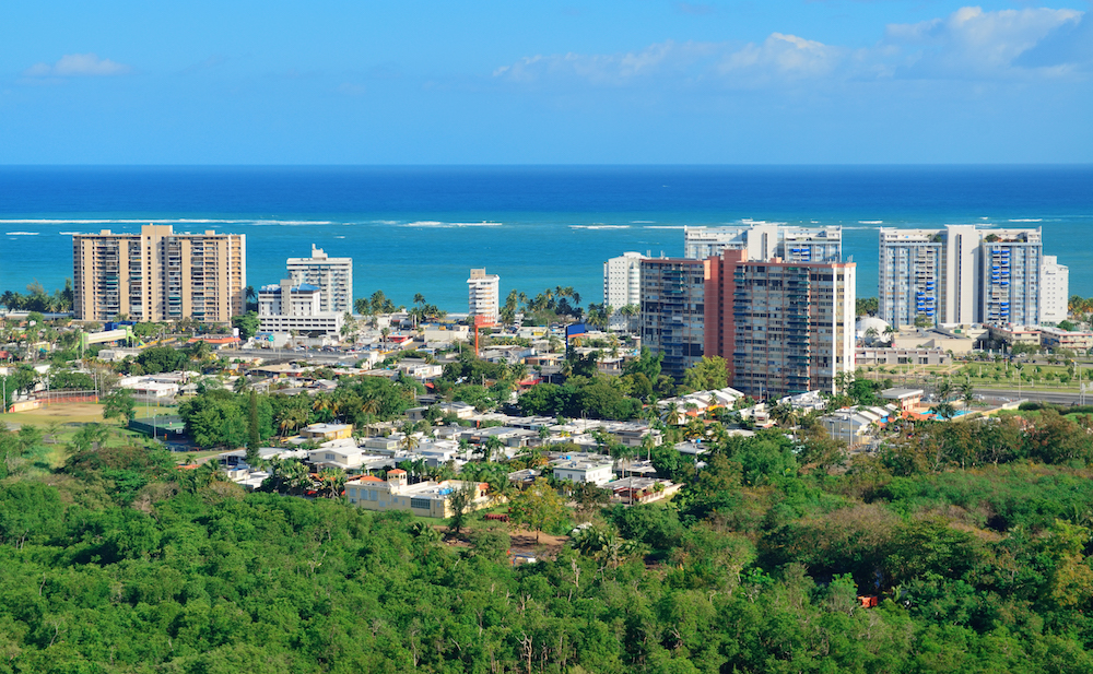 View of island buildings in front of the ocean.