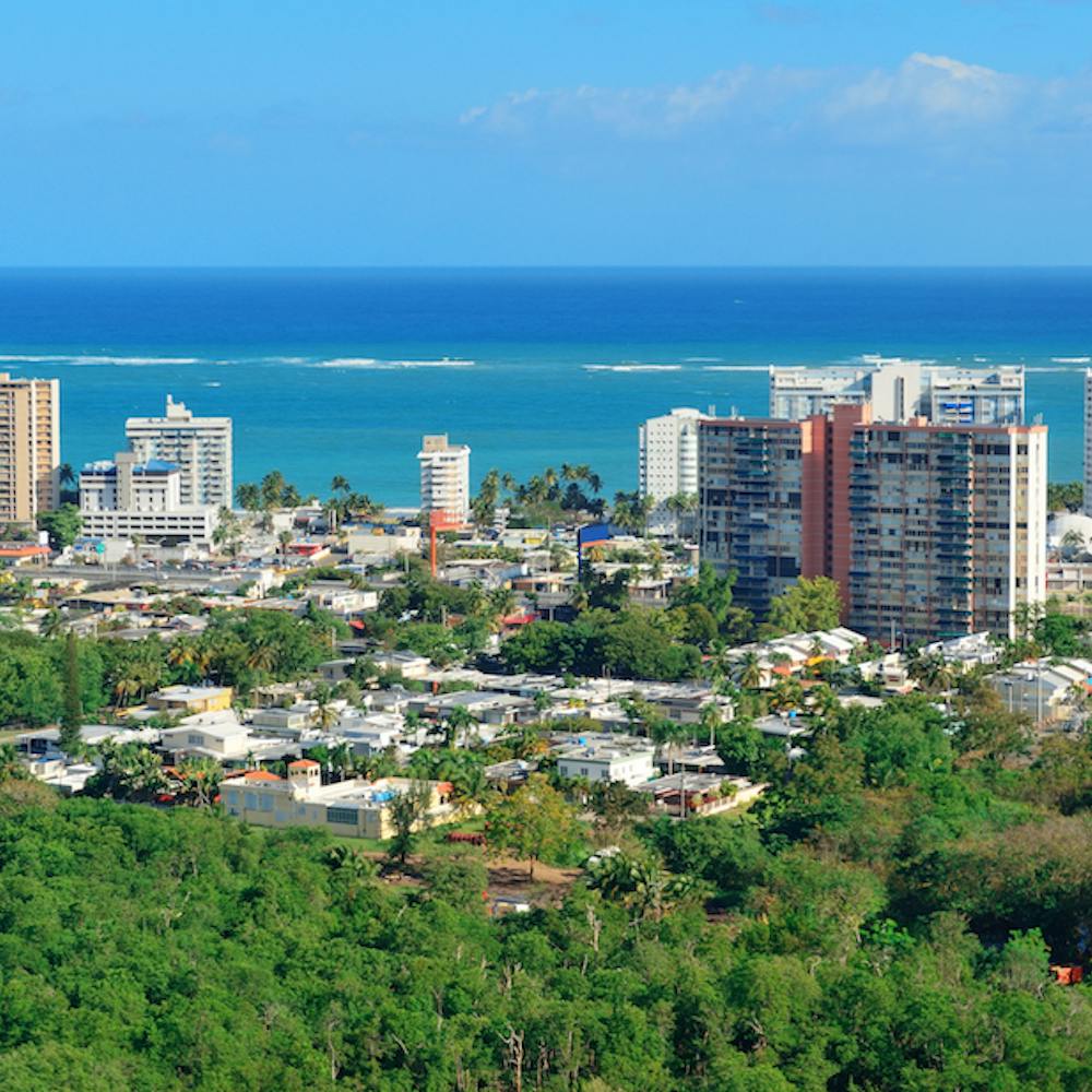 View of island buildings in front of the ocean.