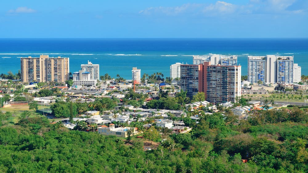 View of island buildings in front of the ocean.