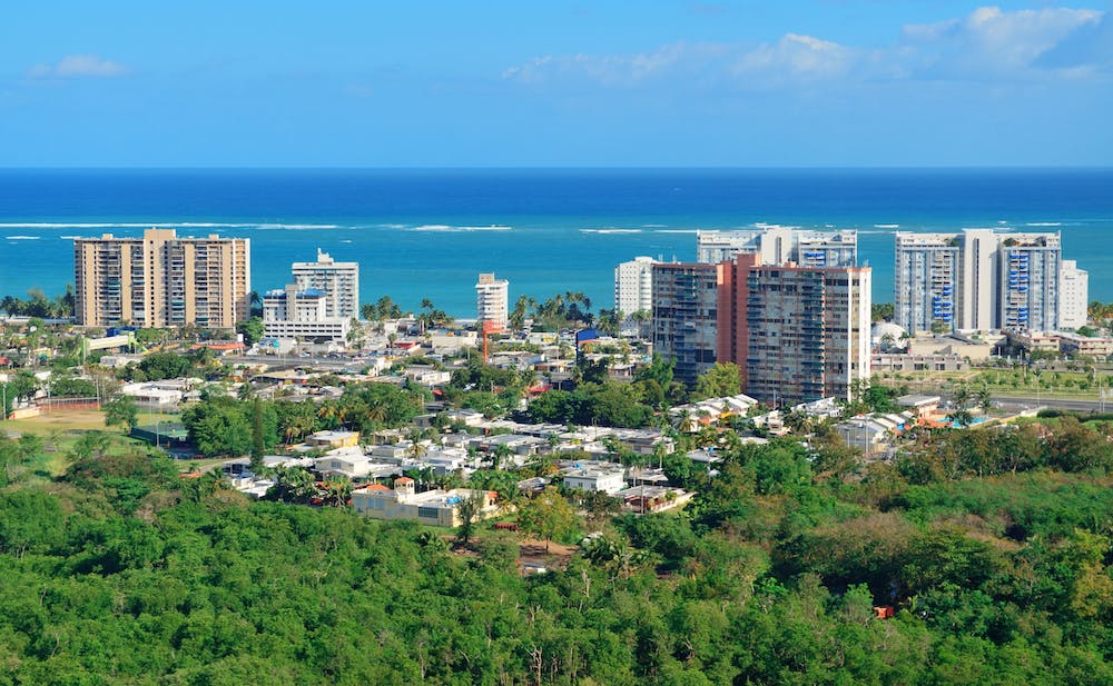 View of island buildings in front of the ocean.