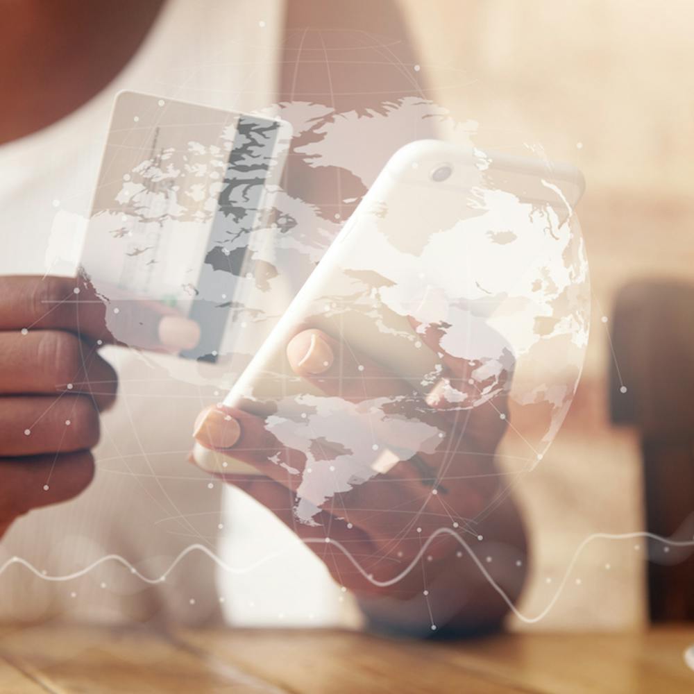 Closeup of credit card and smartphone in woman's hands