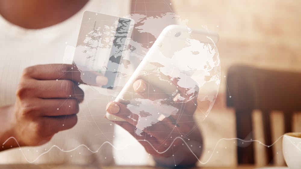 Closeup of credit card and smartphone in woman's hands