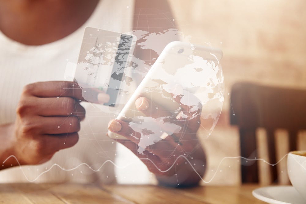 Closeup of credit card and smartphone in woman's hands