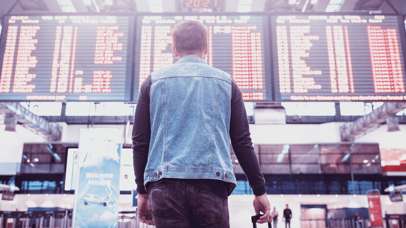 Man looking to a flight schedule panel