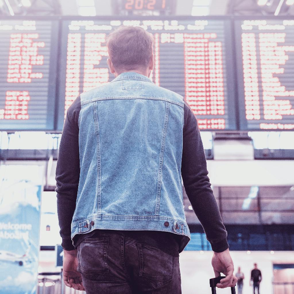 Man looking to a flight schedule panel