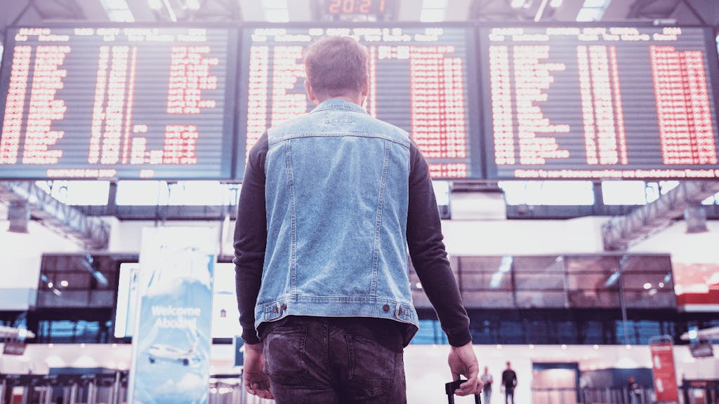 Man looking to a flight schedule panel