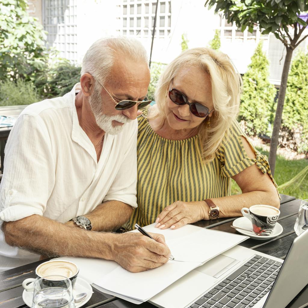 Retired couple taking notes in the diary