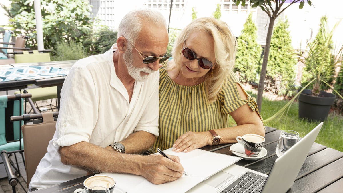 Retired couple taking notes in the diary