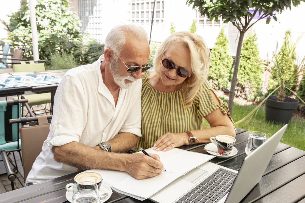 Retired couple taking notes in the diary
