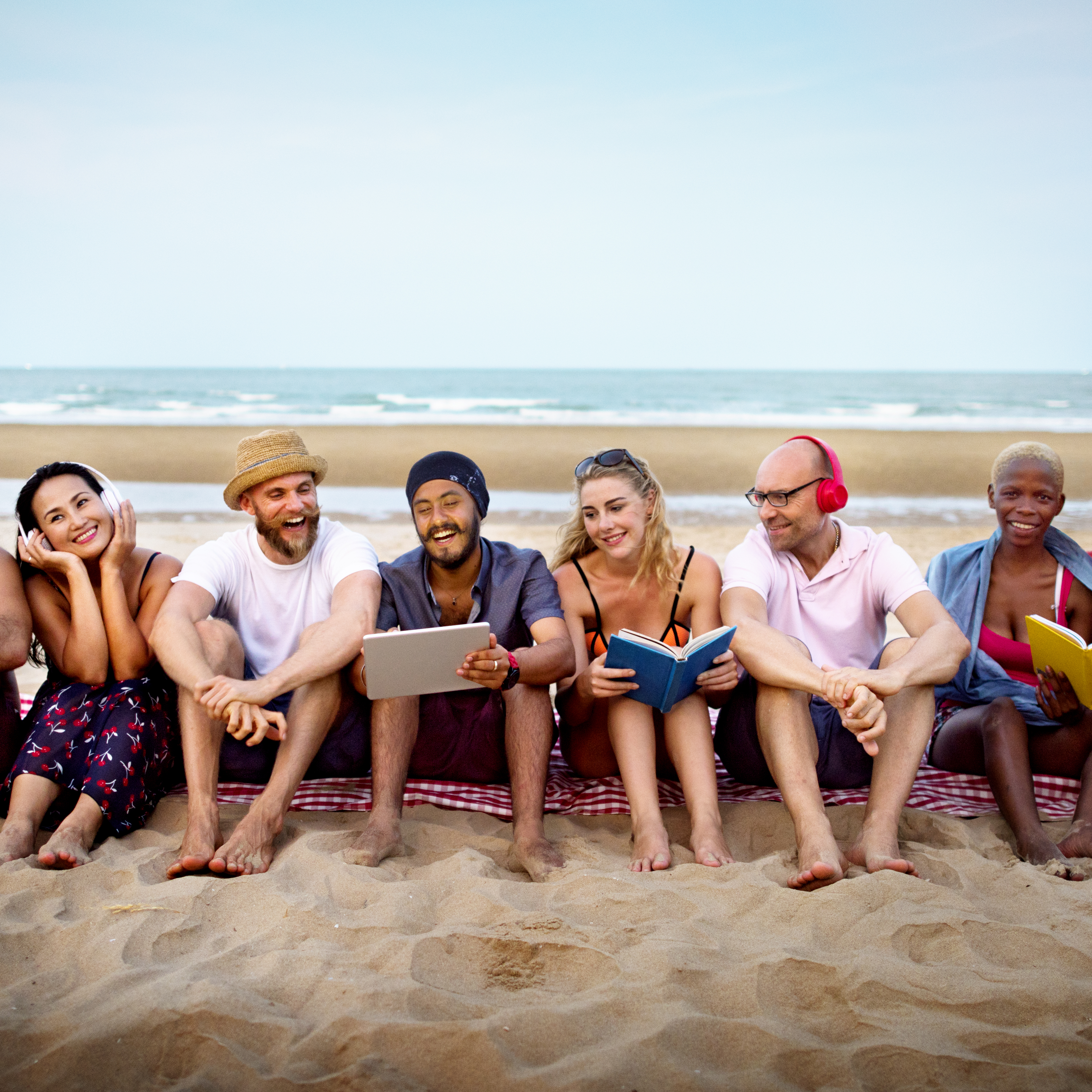 Group of young friend working and smiling together at the beach 