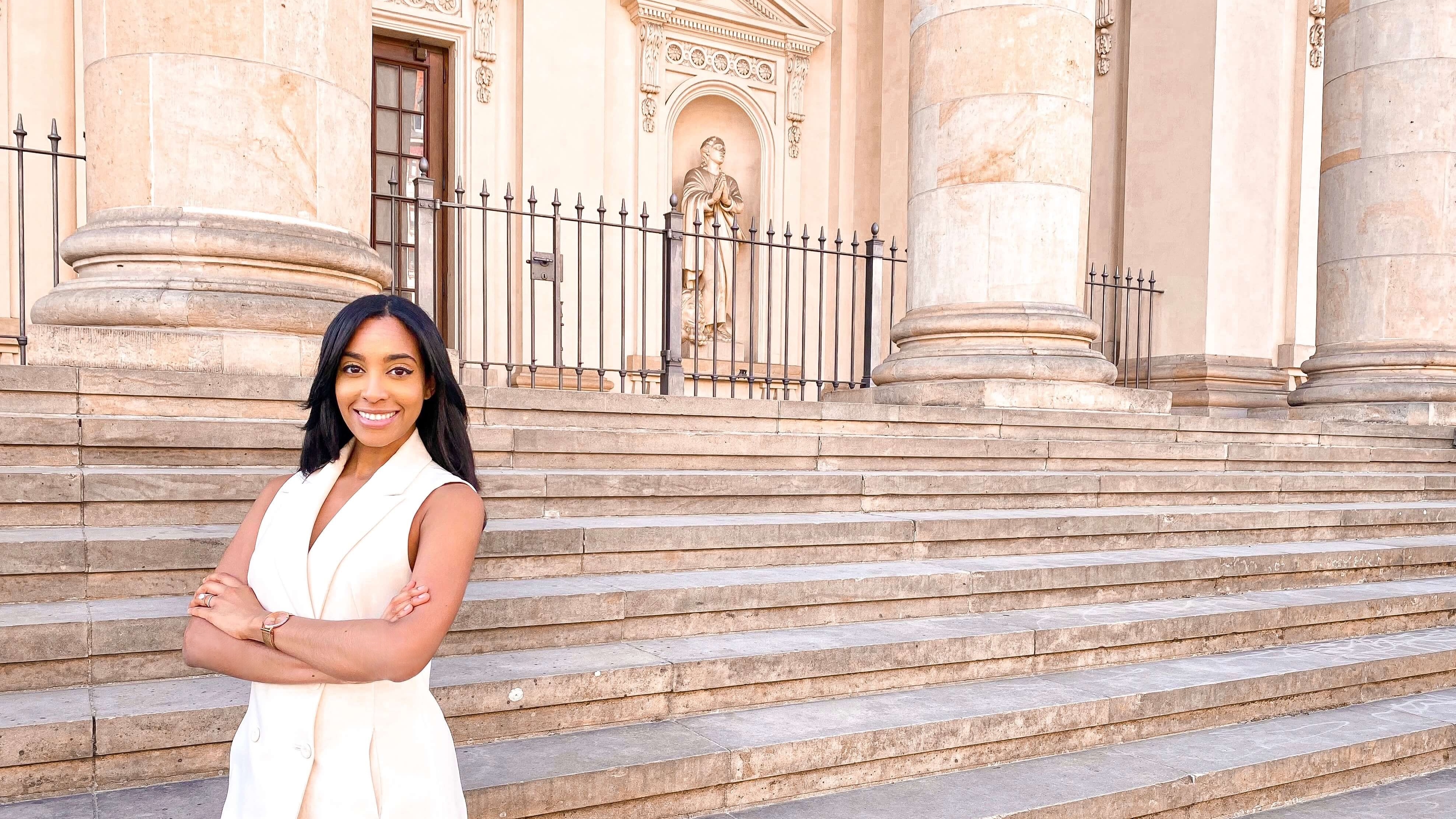 Alexandra stand up in front of a staircase