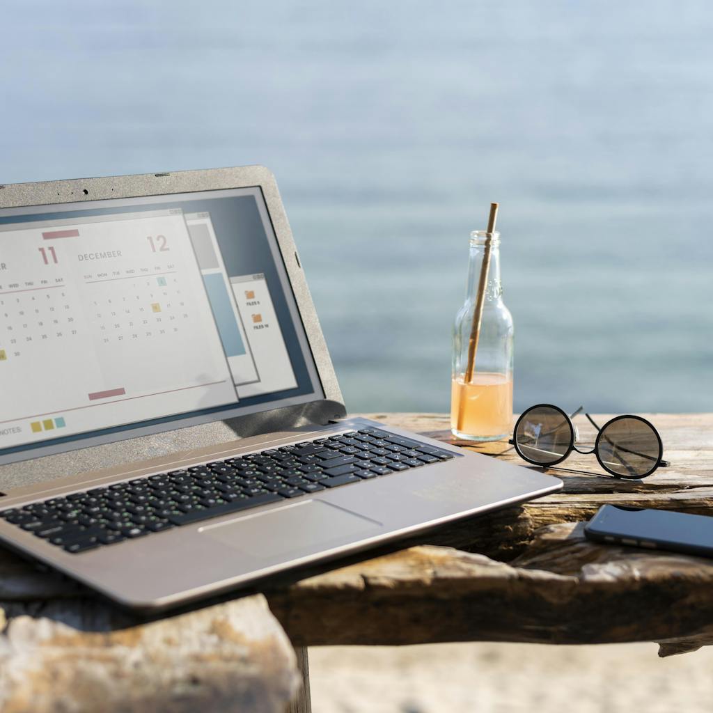 Laptop at seaside Image by <a href="https://www.freepik.com/free-photo/arrangement-with-laptop-seaside_14288139.htm#from_view=detail_serie">Freepik</a>