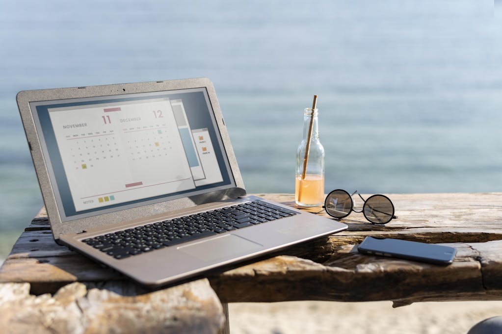 Laptop at seaside Image by <a href="https://www.freepik.com/free-photo/arrangement-with-laptop-seaside_14288139.htm#from_view=detail_serie">Freepik</a>